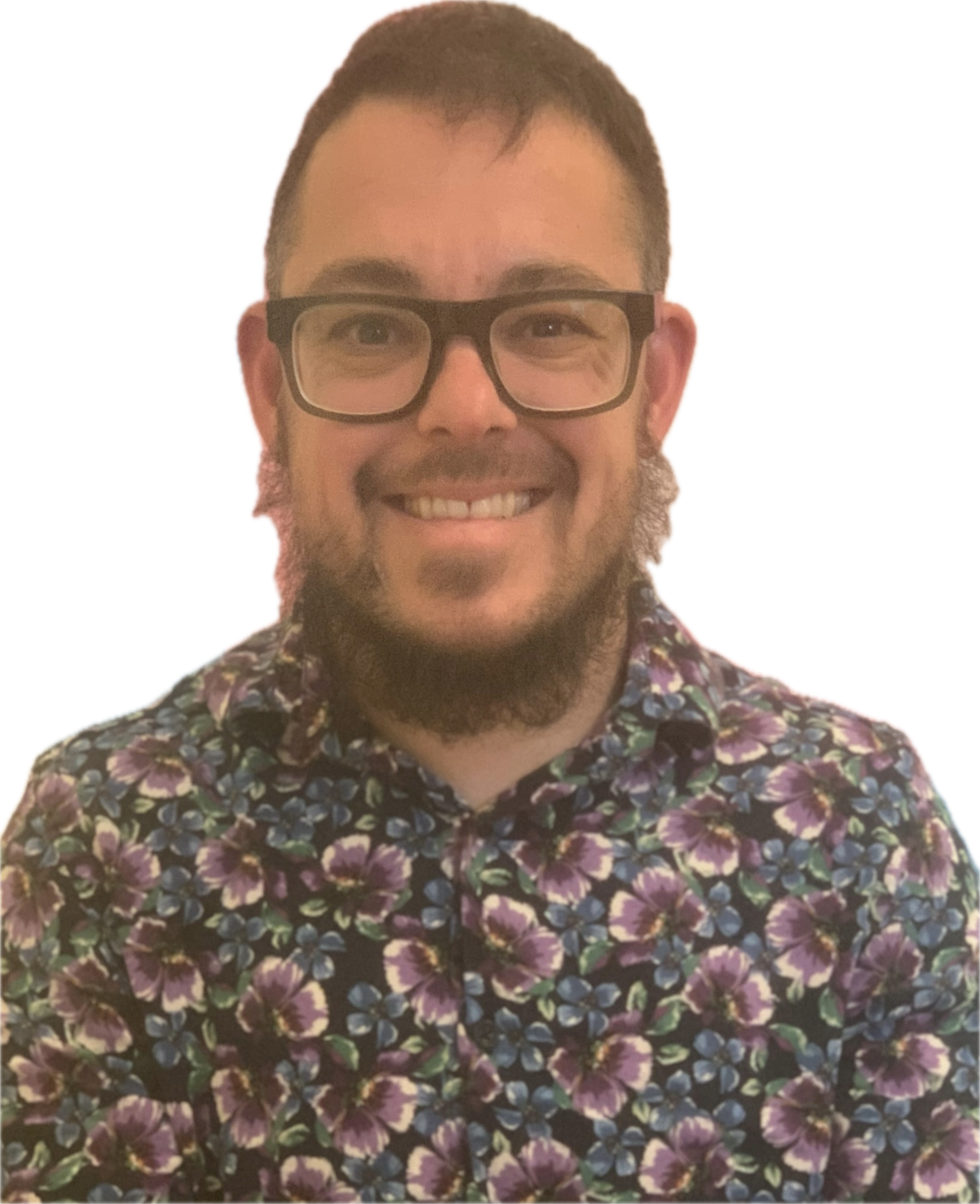 Jax is a caucasian person with glasses, short hair and a beard. He is wearing a flowery top